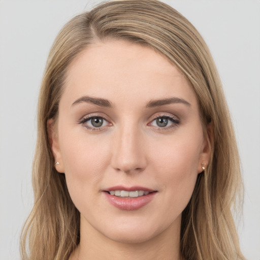 Joyful white young-adult female with long  brown hair and grey eyes