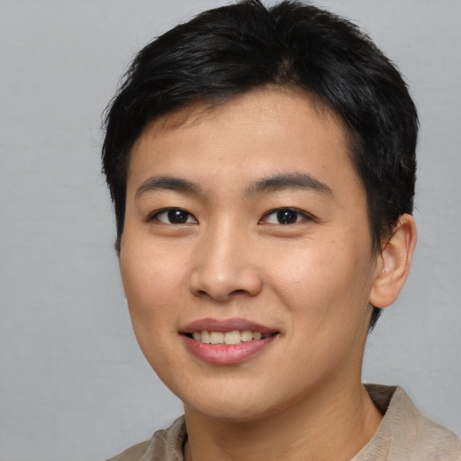 Joyful asian young-adult male with short  brown hair and brown eyes