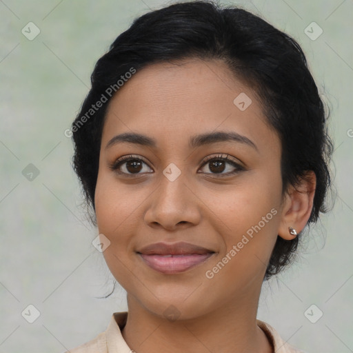 Joyful latino young-adult female with medium  brown hair and brown eyes