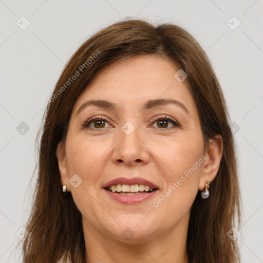 Joyful white adult female with long  brown hair and brown eyes