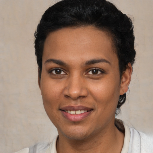 Joyful white young-adult female with short  black hair and brown eyes