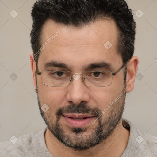 Joyful white adult male with short  brown hair and brown eyes