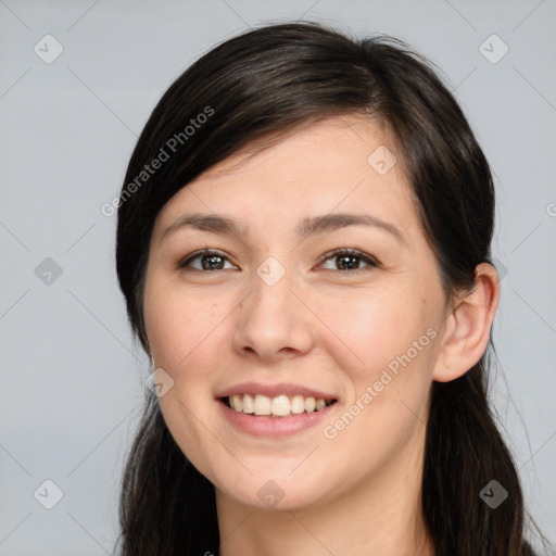 Joyful white young-adult female with long  brown hair and brown eyes