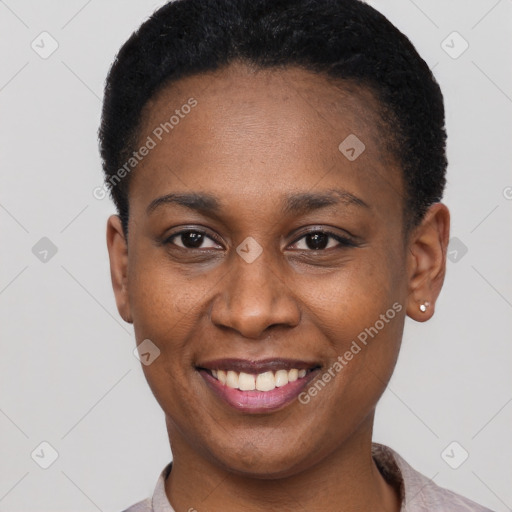 Joyful black young-adult female with short  black hair and brown eyes