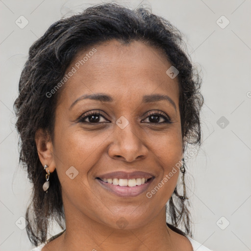 Joyful black adult female with medium  brown hair and brown eyes