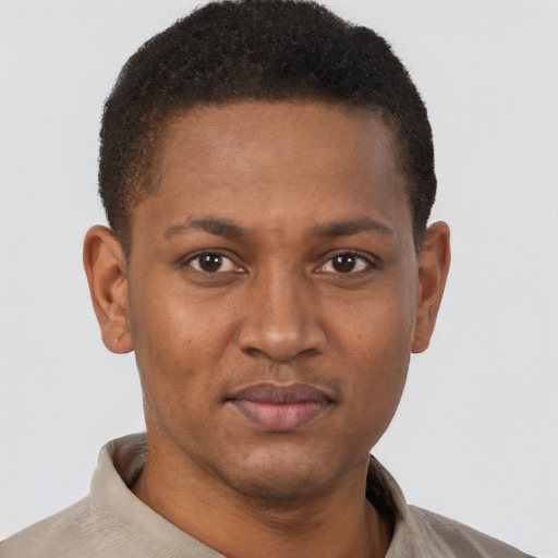 Joyful black young-adult male with short  brown hair and brown eyes