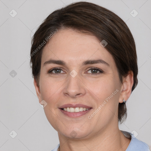 Joyful white young-adult female with medium  brown hair and grey eyes