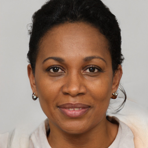 Joyful black adult female with short  black hair and brown eyes
