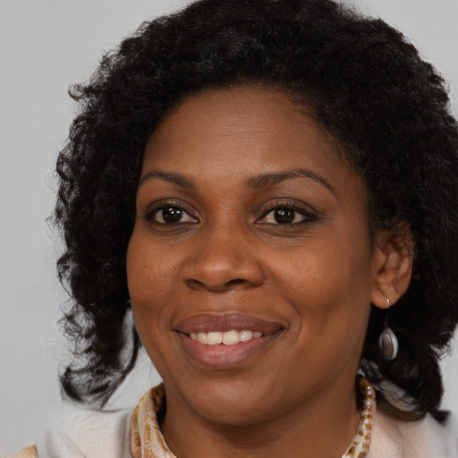 Joyful black young-adult female with medium  brown hair and brown eyes