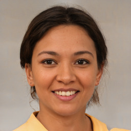 Joyful white young-adult female with medium  brown hair and brown eyes