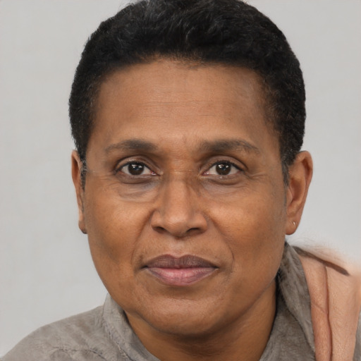 Joyful black adult male with short  brown hair and brown eyes