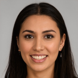 Joyful latino young-adult female with long  brown hair and brown eyes