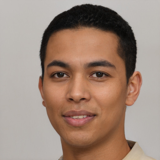 Joyful latino young-adult male with short  black hair and brown eyes