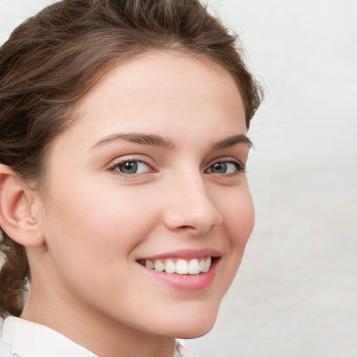 Joyful white young-adult female with medium  brown hair and green eyes