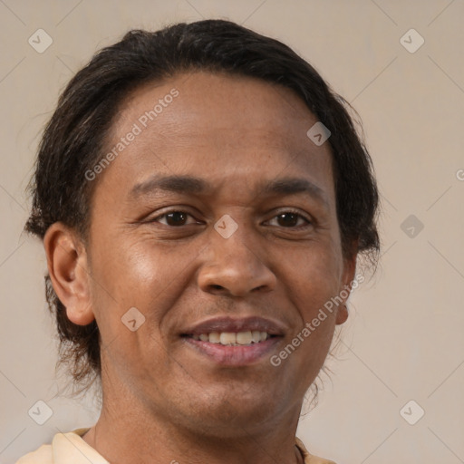 Joyful latino adult male with short  brown hair and brown eyes