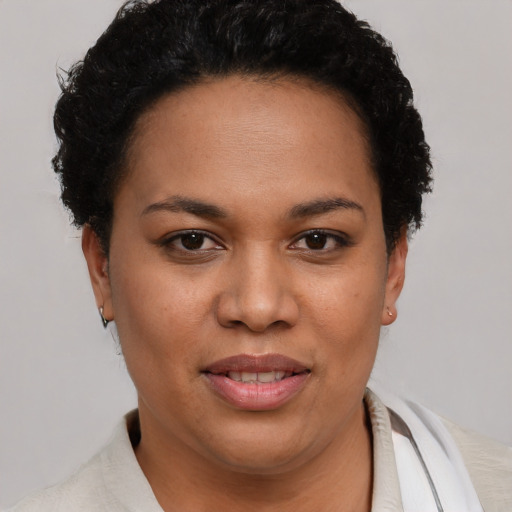 Joyful latino young-adult female with short  brown hair and brown eyes