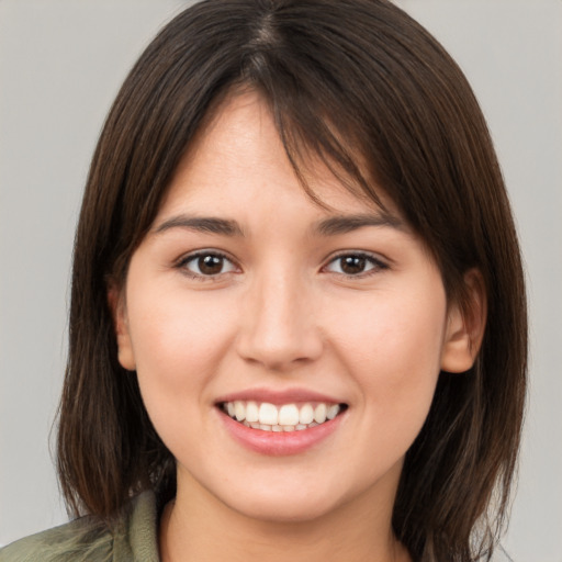 Joyful white young-adult female with medium  brown hair and brown eyes