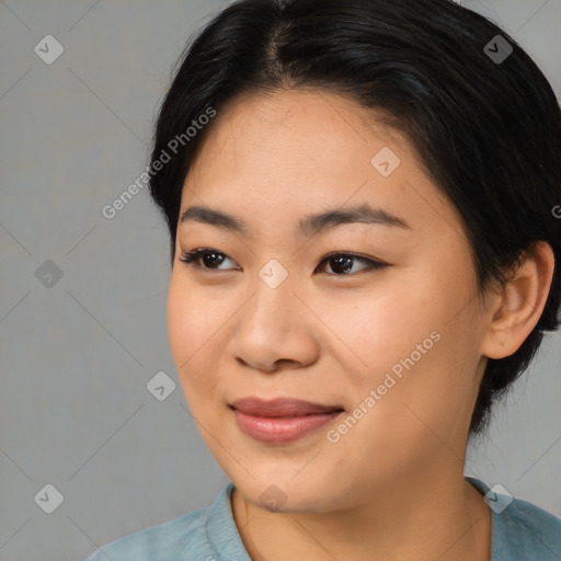 Joyful asian young-adult female with medium  black hair and brown eyes