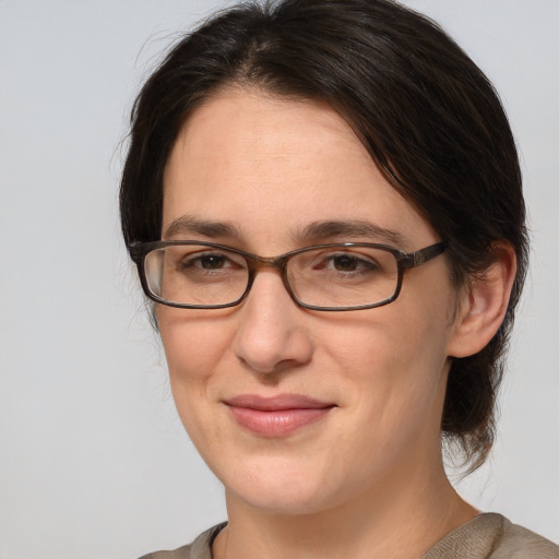 Joyful white adult female with medium  brown hair and brown eyes