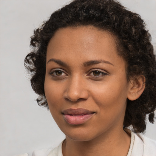 Joyful black young-adult female with medium  brown hair and brown eyes