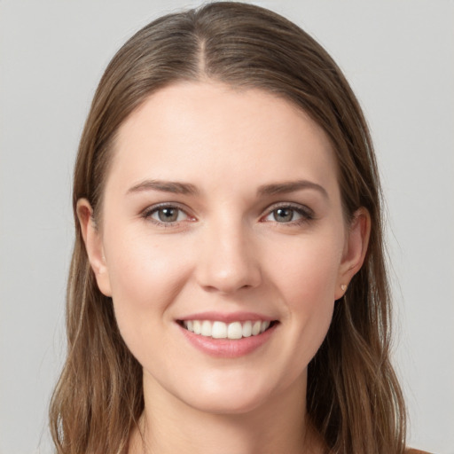 Joyful white young-adult female with long  brown hair and grey eyes