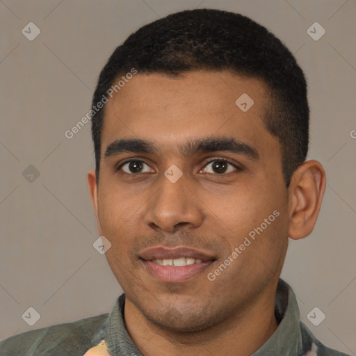Joyful black young-adult male with short  black hair and brown eyes