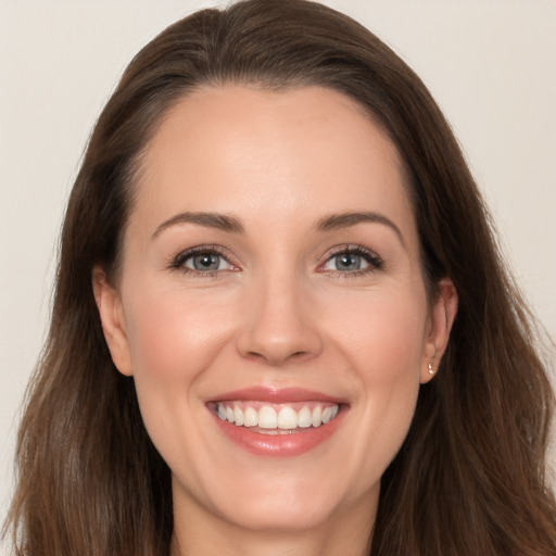 Joyful white young-adult female with long  brown hair and brown eyes