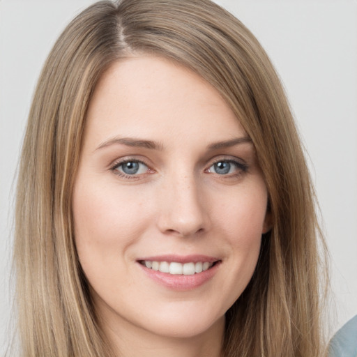 Joyful white young-adult female with long  brown hair and grey eyes