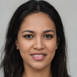 Joyful latino young-adult female with long  brown hair and brown eyes