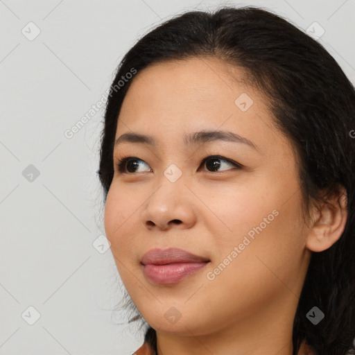 Joyful asian young-adult female with long  brown hair and brown eyes