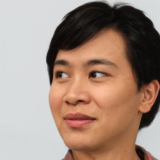 Joyful asian young-adult male with medium  black hair and brown eyes