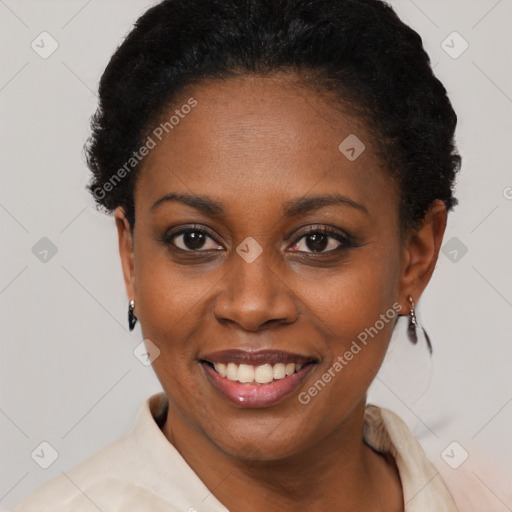 Joyful black young-adult female with short  black hair and brown eyes