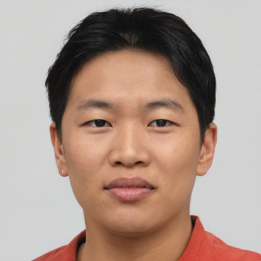 Joyful asian young-adult male with short  brown hair and brown eyes
