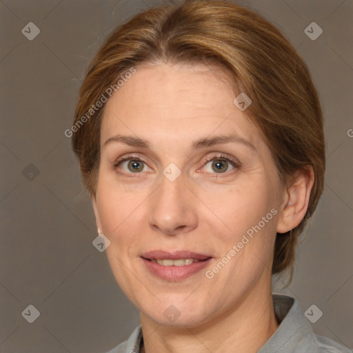 Joyful white adult female with medium  brown hair and grey eyes