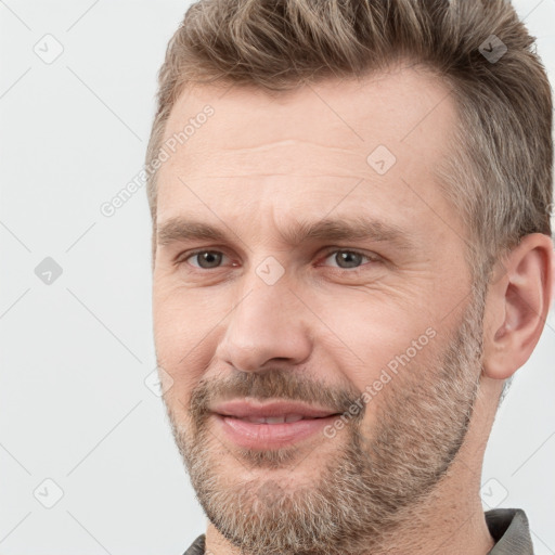 Joyful white adult male with short  brown hair and grey eyes