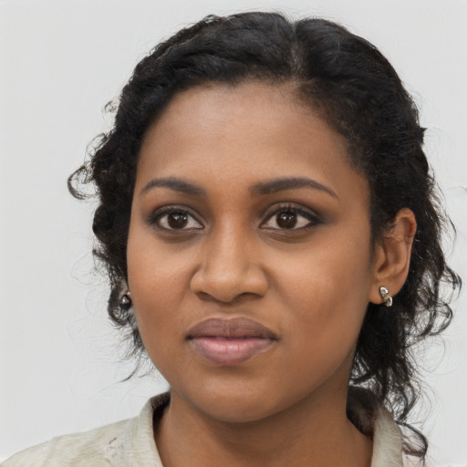 Joyful black young-adult female with medium  black hair and brown eyes