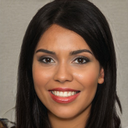 Joyful latino young-adult female with long  black hair and brown eyes