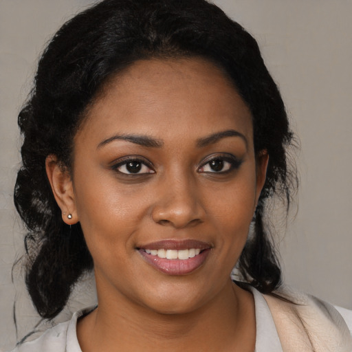 Joyful black young-adult female with medium  black hair and brown eyes