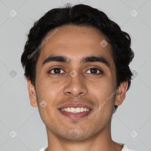 Joyful latino young-adult male with short  brown hair and brown eyes