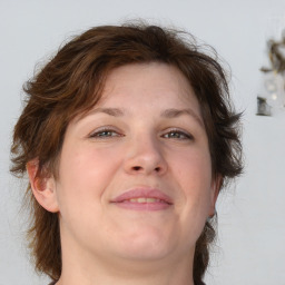 Joyful white adult female with medium  brown hair and grey eyes