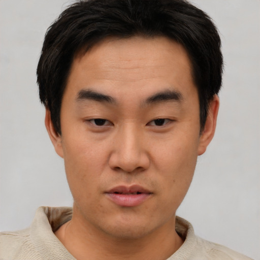 Neutral asian young-adult male with short  brown hair and brown eyes
