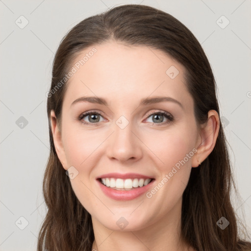 Joyful white young-adult female with long  brown hair and grey eyes