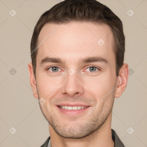 Joyful white young-adult male with short  brown hair and grey eyes