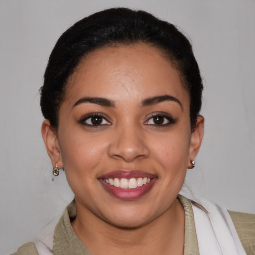 Joyful latino young-adult female with short  brown hair and brown eyes