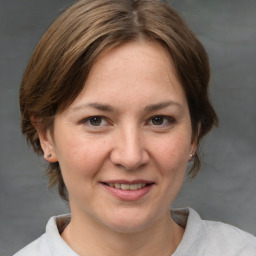 Joyful white adult female with medium  brown hair and brown eyes