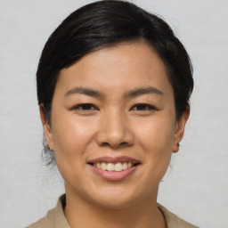 Joyful asian young-adult female with medium  black hair and brown eyes