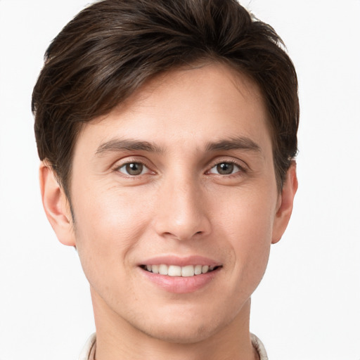 Joyful white young-adult male with short  brown hair and grey eyes