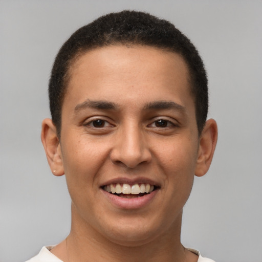 Joyful latino young-adult male with short  brown hair and brown eyes