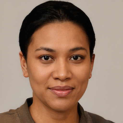 Joyful latino young-adult female with short  brown hair and brown eyes