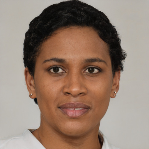 Joyful black young-adult female with short  brown hair and brown eyes